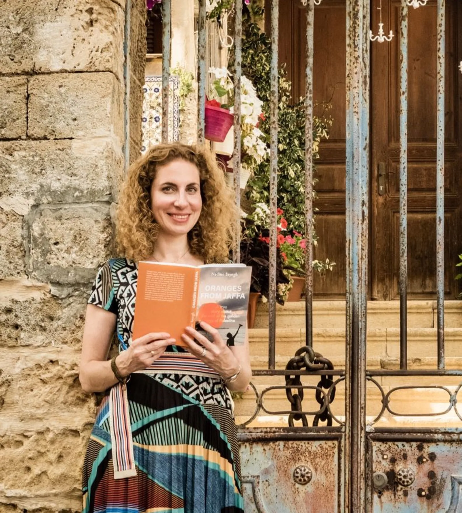 Nadine Sayegh standing in front of her grand-parents house in Jaffa.